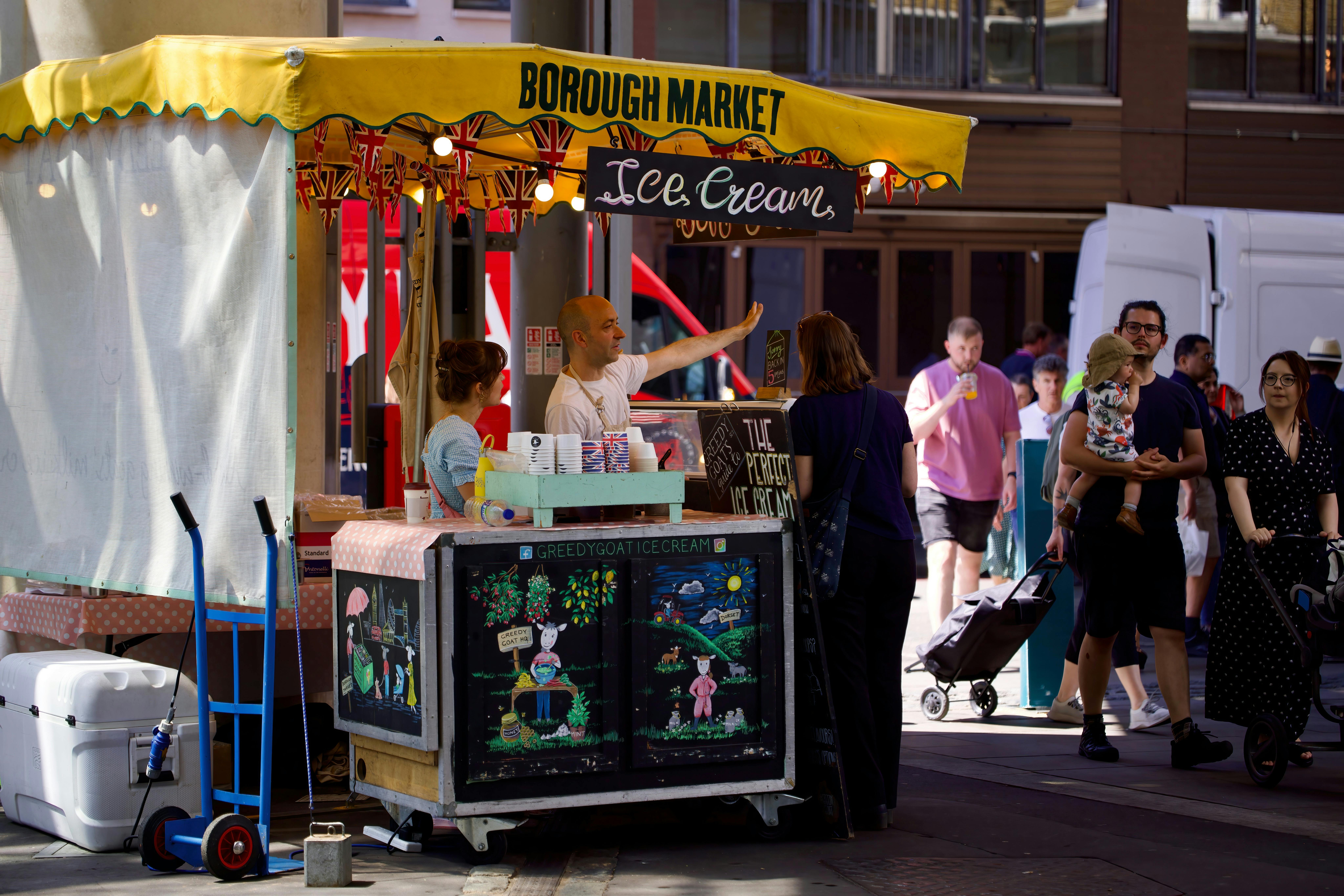 Vibrant scene at Borough Market featuring an ice cream stand and diverse crowd enjoying a sunny day.